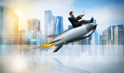 Fast internet concept with a businessman with laptop over a speedy rocket