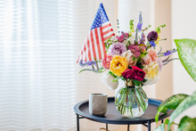 Close Up Of Bouquet Of Flowers In Vase With Usa Flag. Independence Day Of America. Decorated Home For July 4th.
