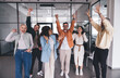 © BullRun - Diverse team celebrating success in workspace