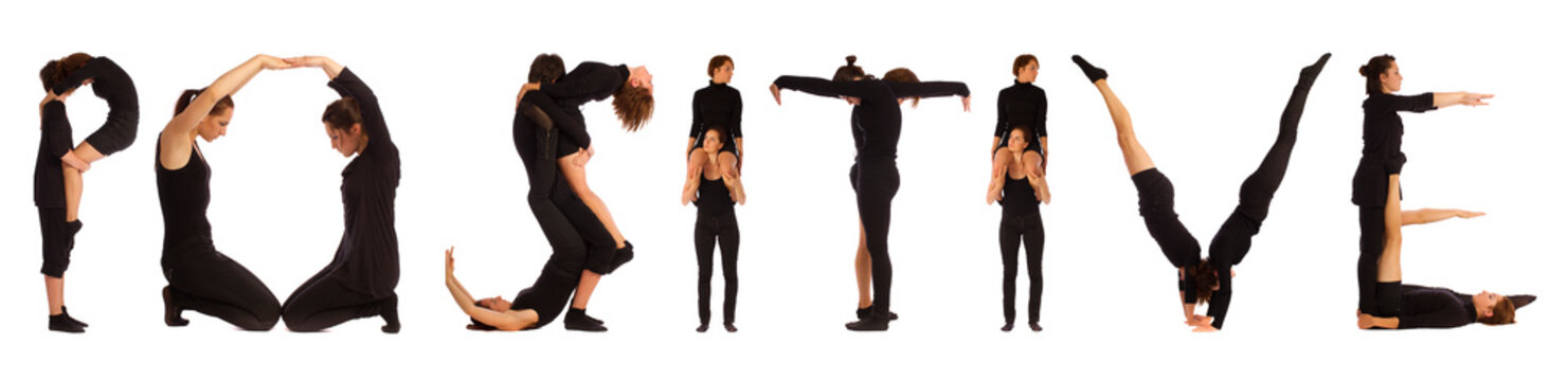 Black dressed people forming word POSITIVE on white background