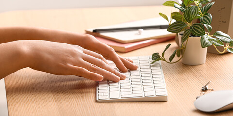 Female programmer using computer keyboard in office, closeup