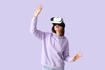 Poster - Pretty young woman in VR glasses on lilac background