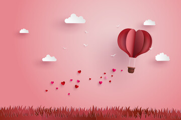 Wall Mural - illustration of love and valentine day,Origami made hot air balloon fly over grass with heart float on the sky.paper art style.