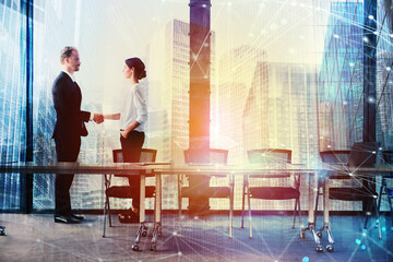 Fototapete - Handshake of two businessperson in a modern office. concept of partnership and teamwork