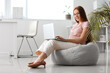 © Pixel-Shot - Female programmer working with laptop in office