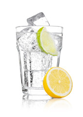 Wall Mural - Glass of sparkling water soda drink lemonade with ice and lime lemon slice on white background