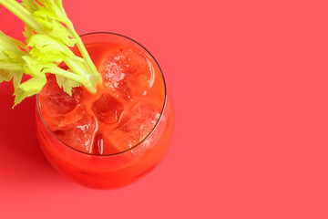 Fototapeta glass of bloody mary with celery on red background