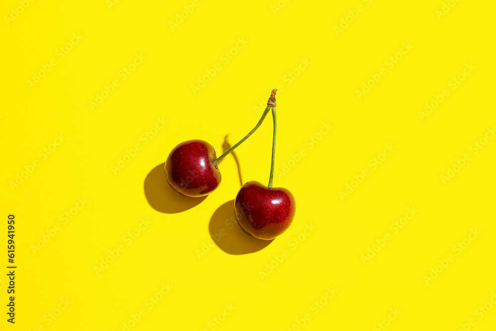 Sweet cherries on yellow background
