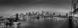 Fototapeta Mosty linowy / wiszący - Brooklyn, Brooklyn park, Brooklyn Bridge, Janes Carousel and Lower Manhattan skyline at night seen from Manhattan bridge, New York city, USA. Black and white wide angle panoramic image.