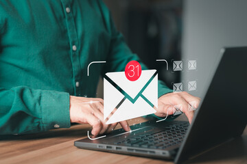Aufkleber - Man hand using computer laptop typing on keyboard and surfing the internet on office table with email icon. Concept of Email marketing, send e-mail or news letter, online working internet network.