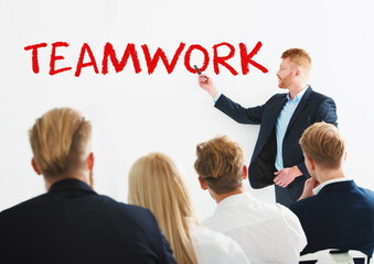Fototapete - Businessman in a meeting room explain something about teamwork at a training meeting