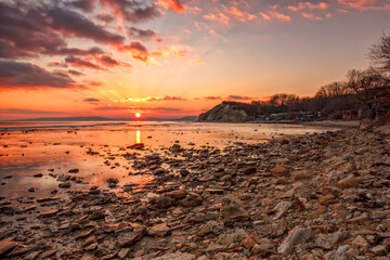 Sticker - Exciting sunset/sunrise on the rocky coast with water reflection