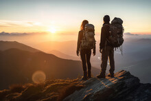 Couple Of Man And Woman Hikers On Top Of A Mountain At Sunset Or Sunrise, Together Enjoying Their Climbing Success And The Breathtaking View, Looking Towards The Horizon - Generative AI