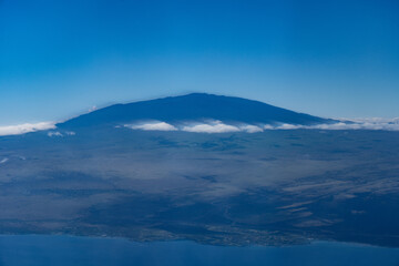 Wall Mural - Mauna Kea,  Big island, Hawaii. Aerial photography on the plane to Kona airport. A shield volcano is a type of volcano named for its low profile, resembling a shield lying on the ground.