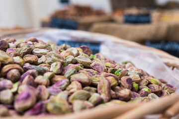 Sticker - Background of basket of pistachios without shells, captured on street market, selective focus