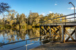 Beautiful scenery at Moama Wharf in Echuca VIC Australia. Trees in the sunset and water reflection on Murray River in the background.