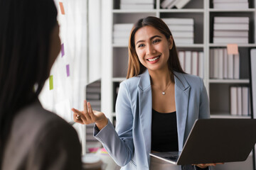 Businesswoman working on laptop to explaining financial data of new business project to partner