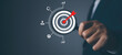 © nuruddean - Businessman using magnifying glass with management target, success and planning.