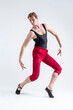 © danmorgan12 - Concentrated Contemporary Ballet Dancer Flexible Athletic Man Posing in Red Tights in Ballanced Dance Pose on White.