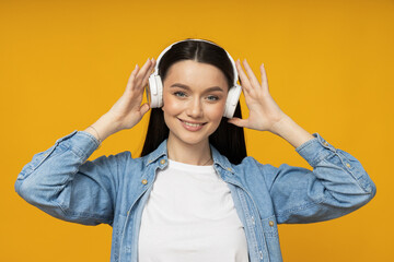 Poster - A young woman in a denim shirt and headphones