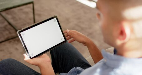 Biracial man making video call using tablet with copy space on screen, slow motion