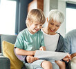 © Lumos sp - grandchild family child grandparent grandfather happy together grandmother girl senior boy read book education granddaughter grandson sofa