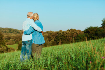 Wall Mural - woman man outdoor senior couple happy lifestyle retirement together smiling love hug nature mature