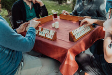 A Group Of Men Drink Traditional Turkish Tea And Play A Turkish Game Called Okey