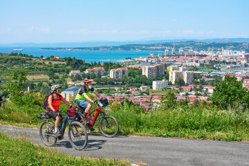 active senior couple on a mountain bike tour at Capodistria, Slovenian Mediterranen cost above city of Koper