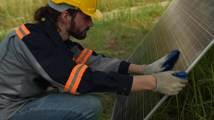 Wall Mural - Engineer hand is installing and checking an operation of sun and cleanliness of photovoltaic solar panels, Engineer with energy measurement tool photovoltaic modules for renewable energy