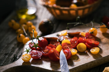 Various selection of tomatoes, brown, yellow, red and green. Sorted and arranged for baking.