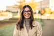 © Andrei - Cheerful LGBT female student wearing glasses joyfully smiling beautifully in front of campus