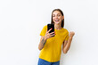 © F8  \ Suport Ukraine - Portrait of a happy woman holding mobile phone and celebrating a win isolated over white background