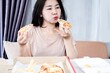 fast food addiction with unhealthy Asian woman overeating pizza, Binge eating disorder concept