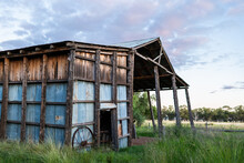 Dilapidated Old Farm Hay Shed At Dusk On Australian Farm