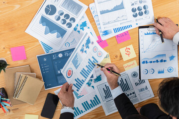 Poster - Top view analyst team discussing financial data on digital dashboard, analyzing chart and graph papers by data science software on wooden table background. Business intelligence and Fintech. Fervent