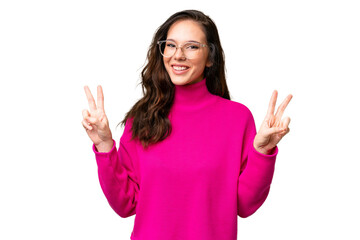 Wall Mural - Young caucasian woman isolated over isolated background showing victory sign with both hands