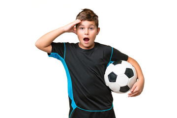 Wall Mural - Little caucasian football player kid over isolated chroma key background with surprise expression