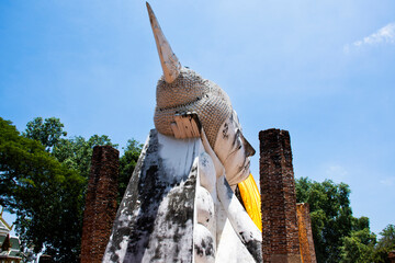 Ancient antique white buddha reclining attitude statue of Wat Khun Inthapramun temple for thai people traveler travel visit and respect praying blessing wish holy mystery worship in Ang Thong Thailand