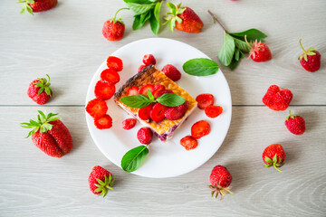 Wall Mural - cooked cottage cheese casserole with berry and strawberry filling in a plate