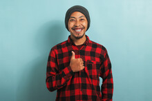 Asian Man With Beanie Hat And Red Plaid Flannel Shirt Showing Thumb Up
