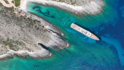 Wall Mural - Aerial drone photo of beautiful turquoise beach and cave formations visited by yachts in Southern part of Antiparos island, Cyclades, Greece