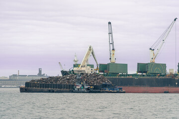 Trash Collection Boat in the Bay of NYC Moving Trash to Cargo Ship