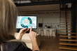 © Angelov - Iot Smart Home Concept - rear view of woman ask digital tablet to set temperature of air conditioner more higher by voice at home and all the electric meter in house getting energy-efficient
