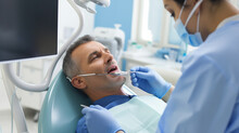 A Dentist In Protective Gear, Performing A Dental Procedure On A Patient, Emphasizing Oral Health And Dental Care Generative AI