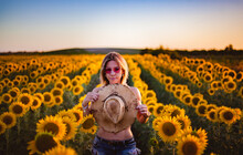 Elegant And Sensual Woman In A Field Of Sunflowers In El Puerto De Santa Maria, Andalucia Spain