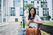 © ChaoticMind - Young Japanese woman reading a message on the mobile phone in the city