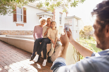 Sticker - Picture, family and happy grandma, mother and child bonding, smile and father taking outdoor generations photo. Cellphone, support and happiness of young kid, mom and elderly grandma in home backyard