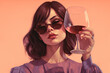 Beautiful woman dressed in pink and amber holds a glass in her hand created with Generative AI technology