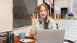 © Pichsakul - Business concept, Woman entrepreneur greeting colleague on video call in coworking space office